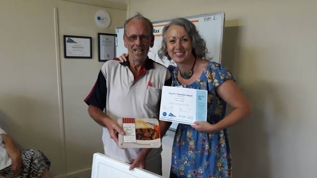 Dignity Champion Denis Arnott gives away prize